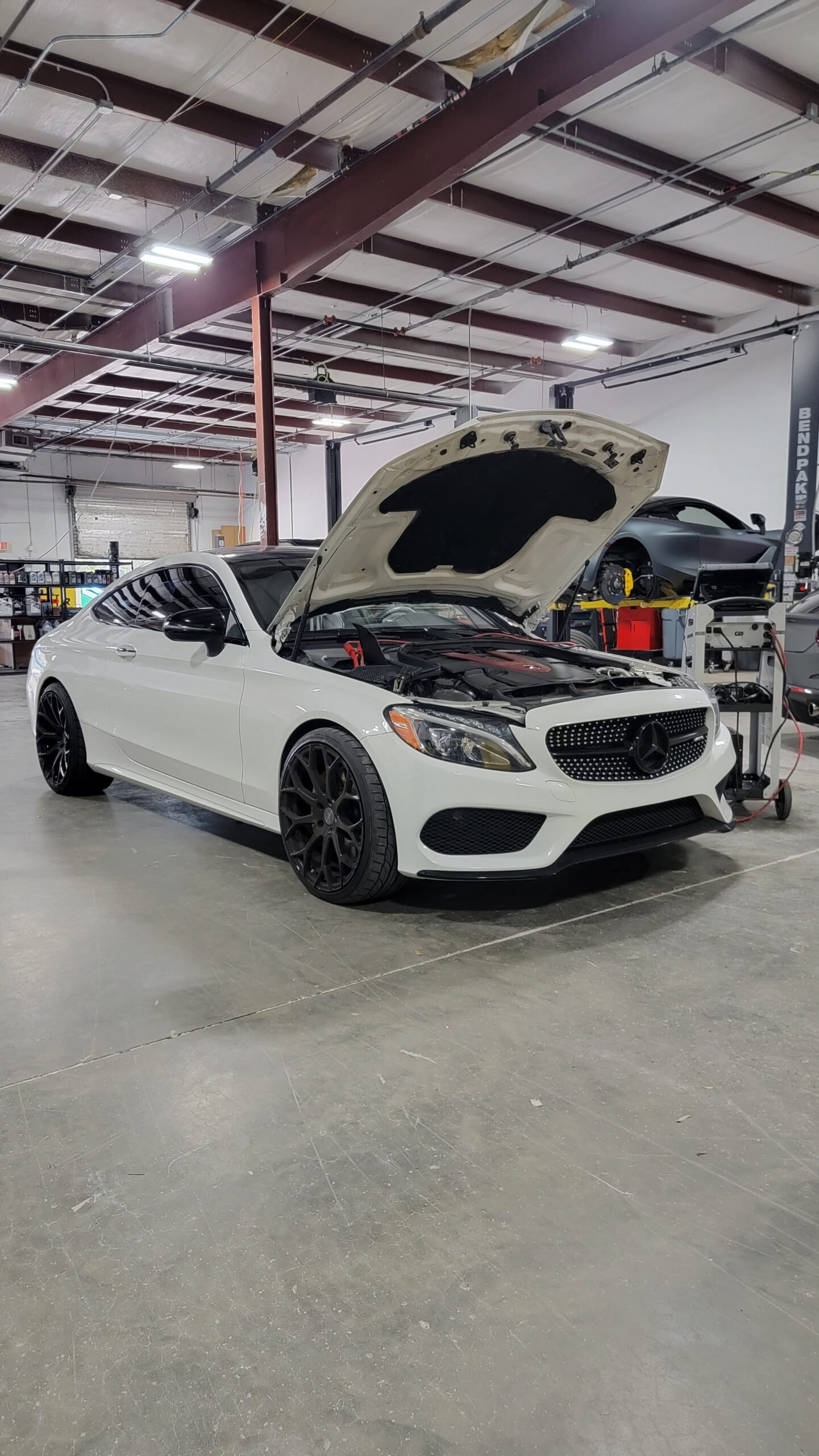 Mercedes-Benz C-Class with the hood open during service at Eurocraft Automotive in Orlando